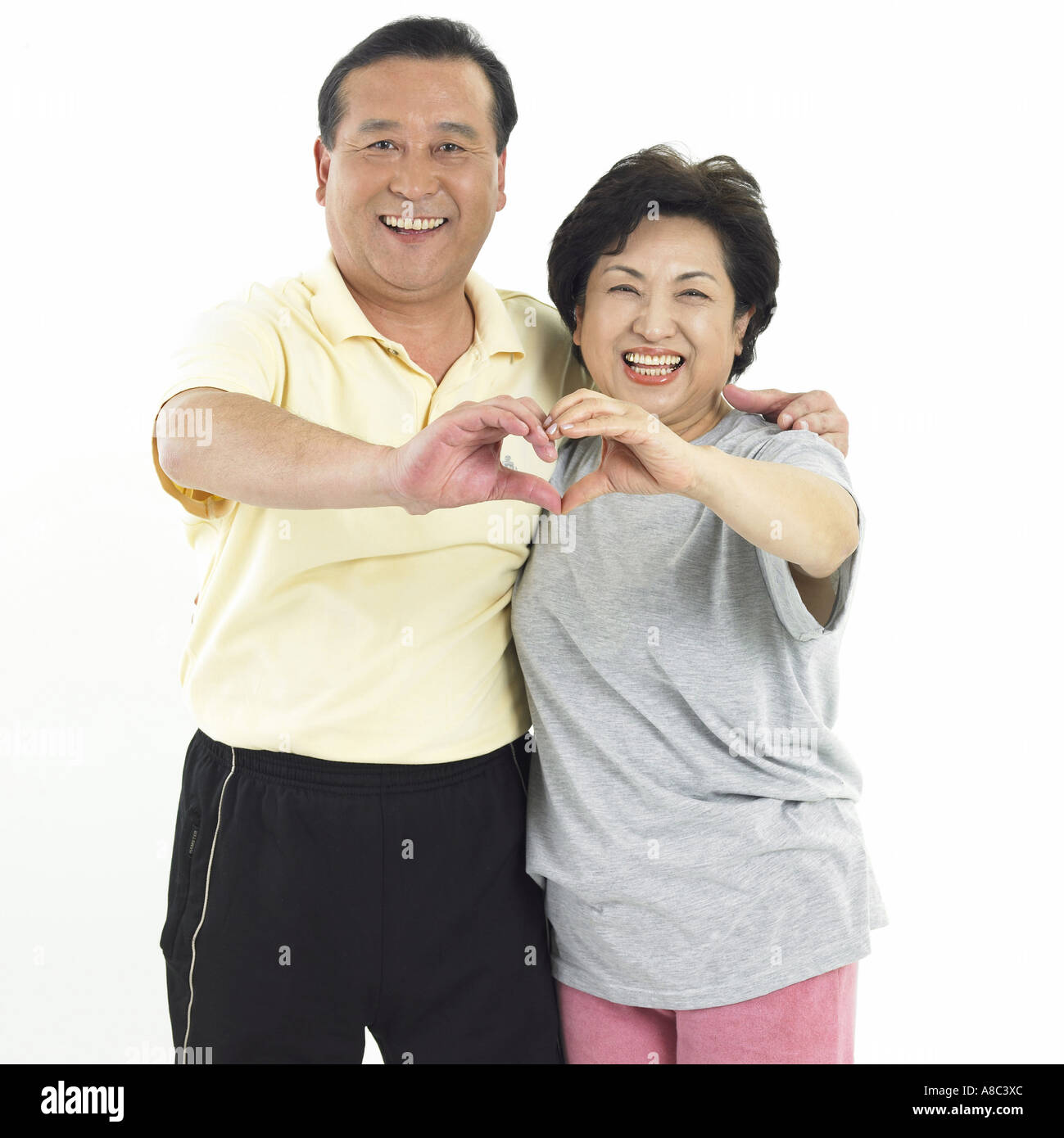 The old an old couple drawing heart in the air Stock Photo