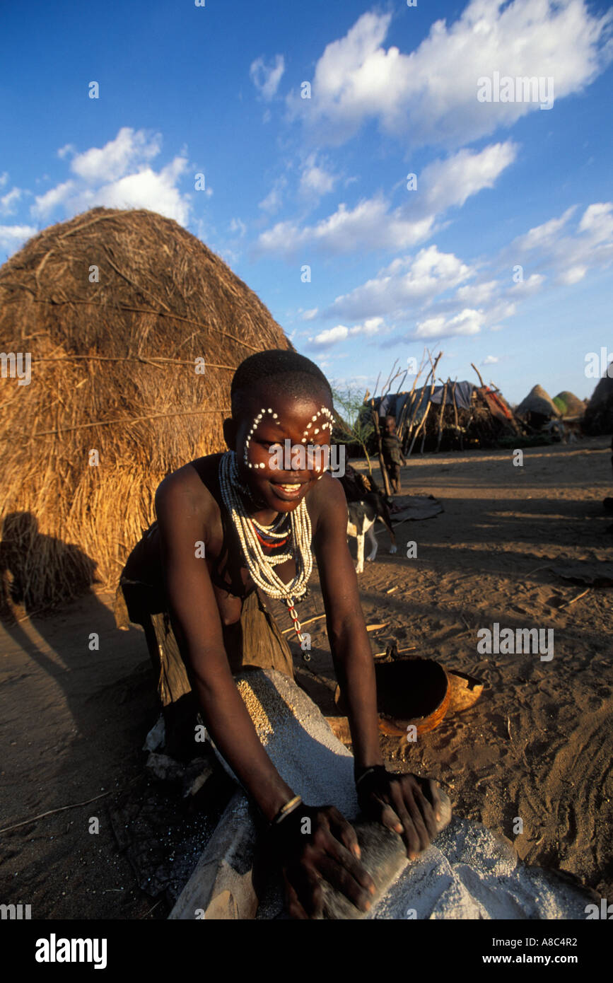 Karo woman grinding maize , Kolcho , South Omo valley , Ethiopia Stock