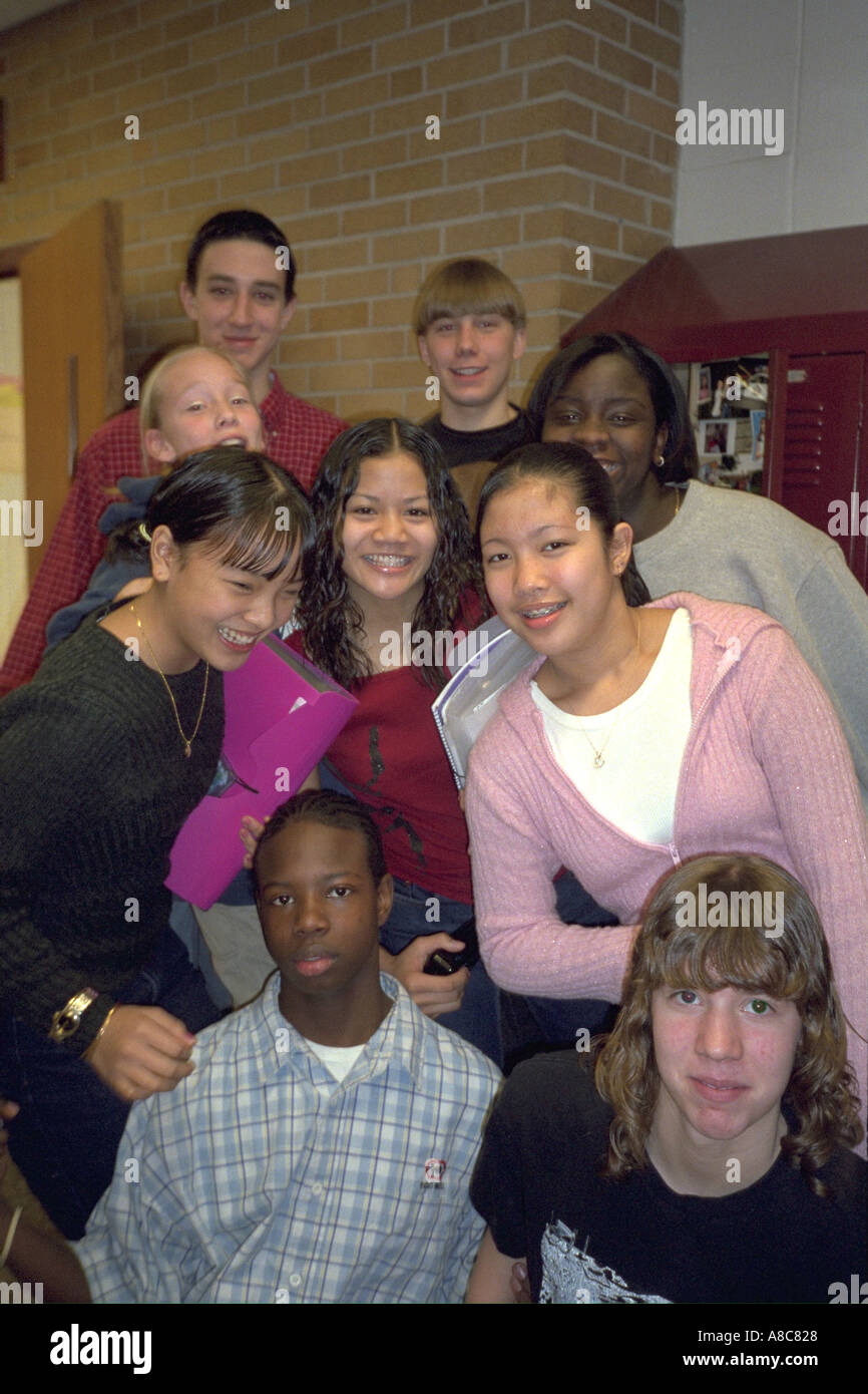 Group of students age 15 in front of school hallway lockers between class. Golden Valley Minnesota USA Stock Photo