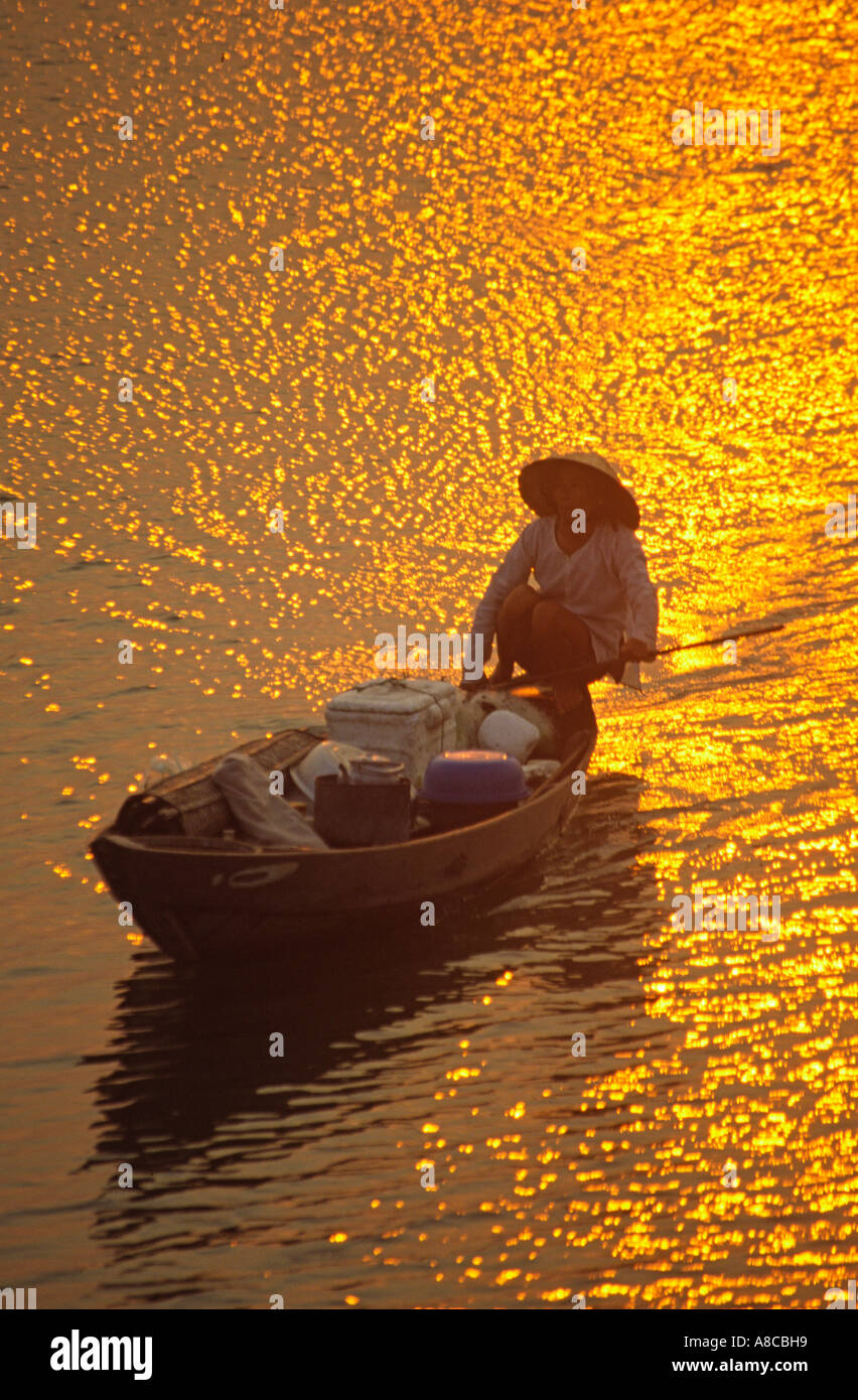 VNM Vietnam Nha Thrang river delta at sunset woman on a fisherboat Stock Photo