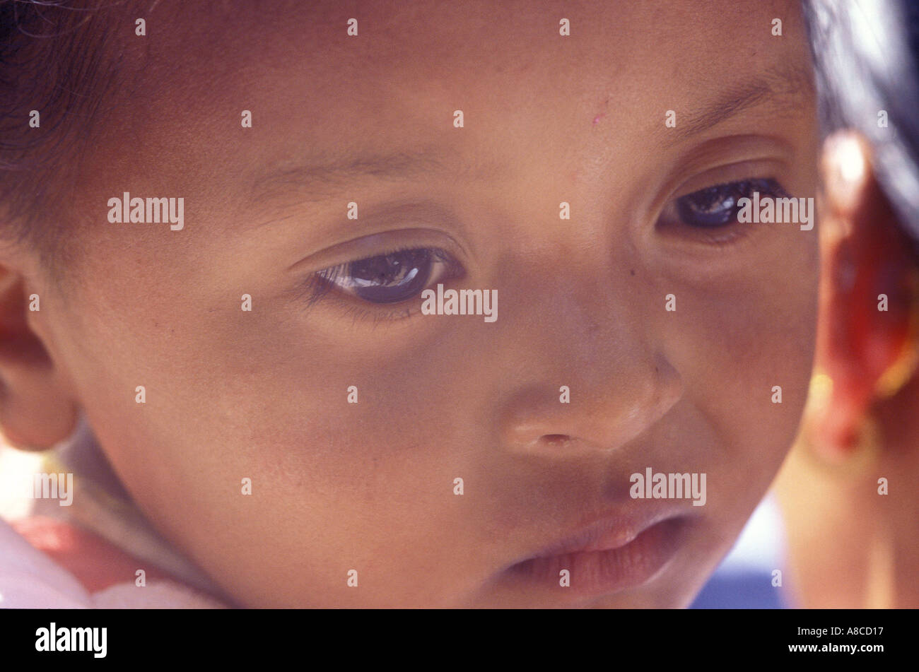 A child in mothers arms during New year festival, Bhaktapur Nepal Stock Photo