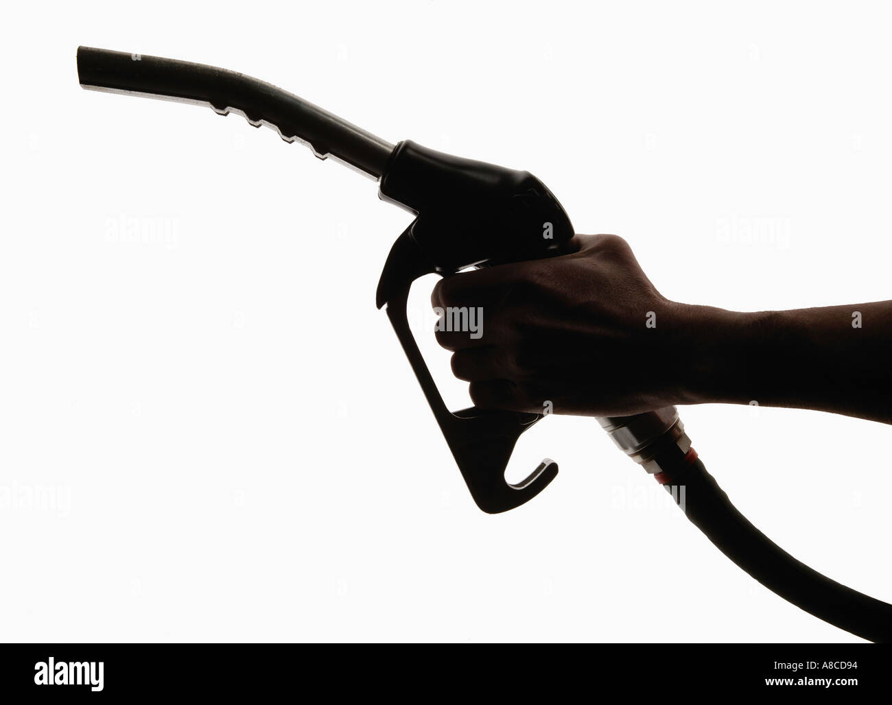 HAND HOLDING PETROL NOZZLE PUMP IN SILHOUETTE Stock Photo Alamy