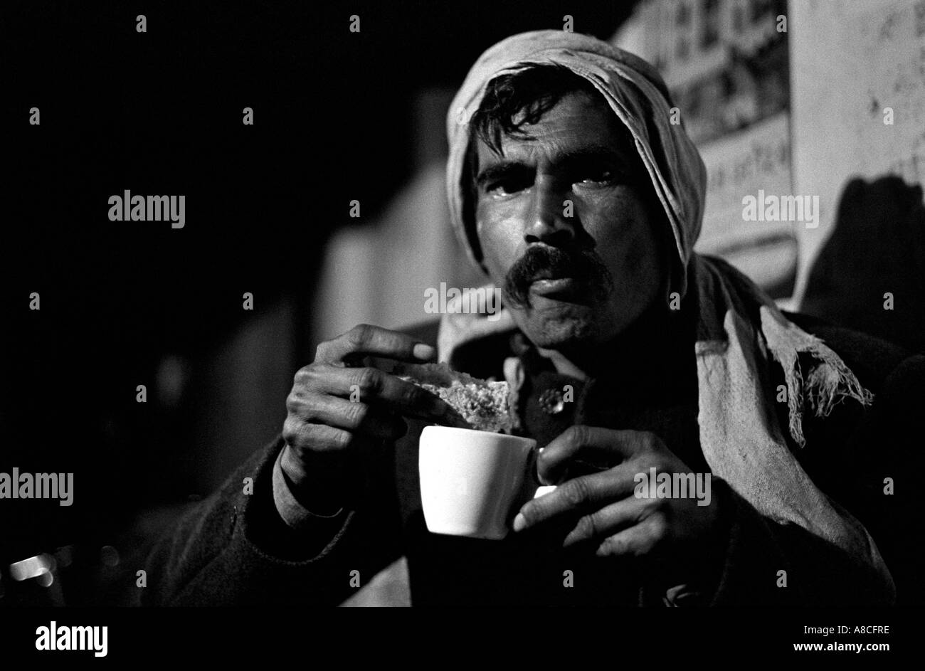 Man drinking tea at a night stall in Agra, Uttar Pradesh India