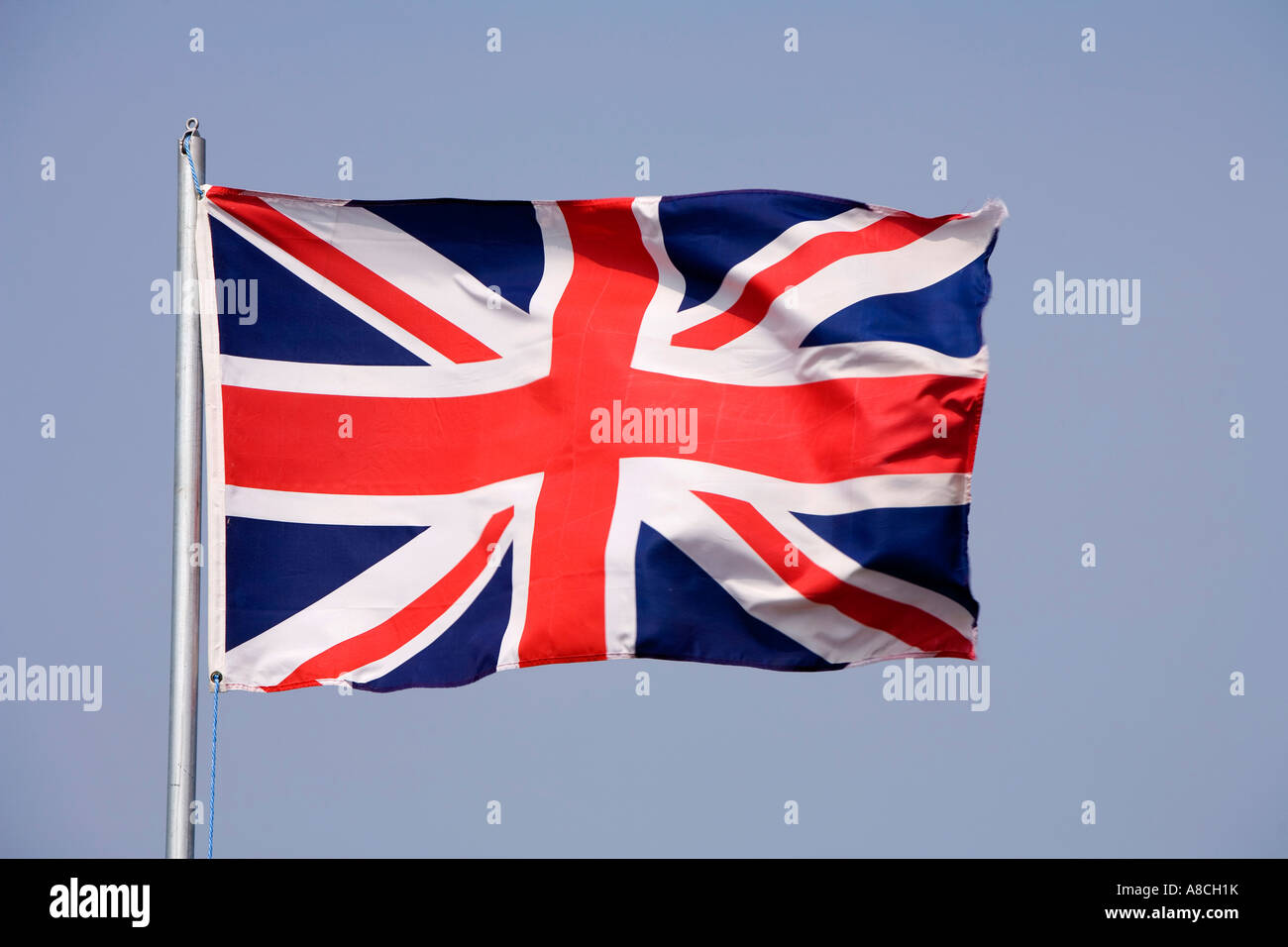 nationality British Union Jack flag flying in strong wind Stock Photo