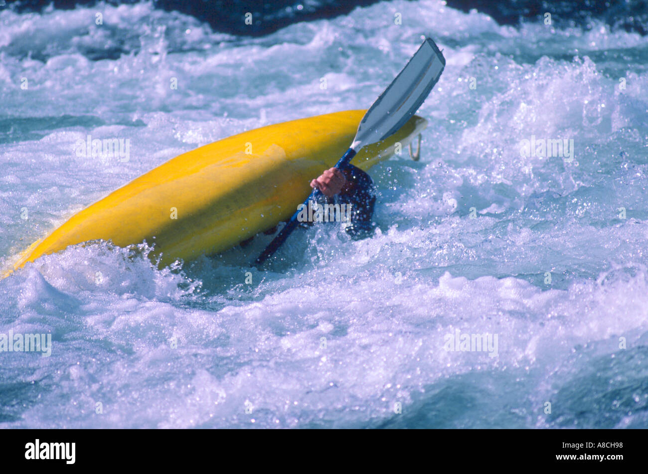 whitewater kayaking kayaker upside down in middle of Eskimo roll