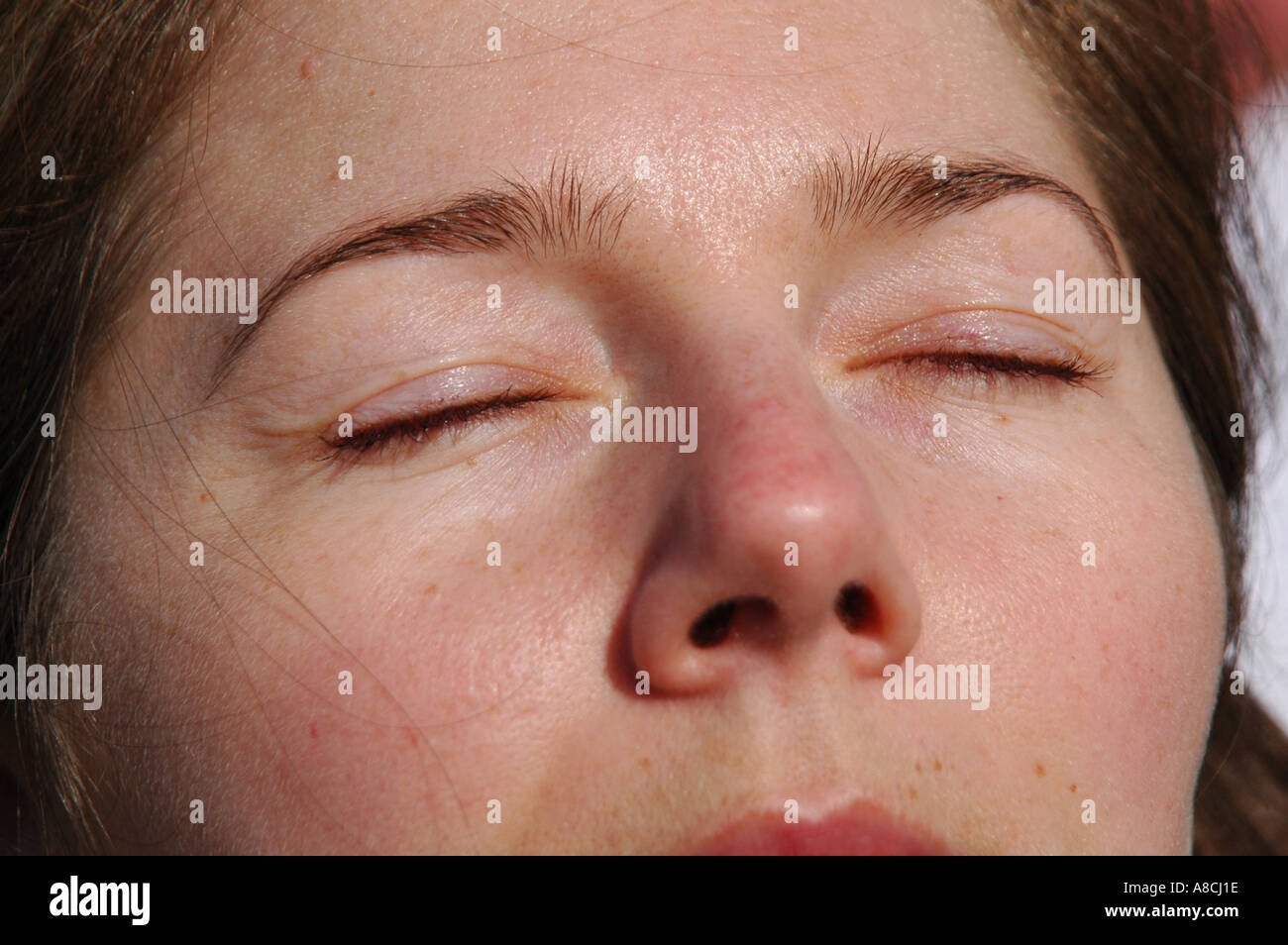 Woman exposing face to sun Stock Photo - Alamy