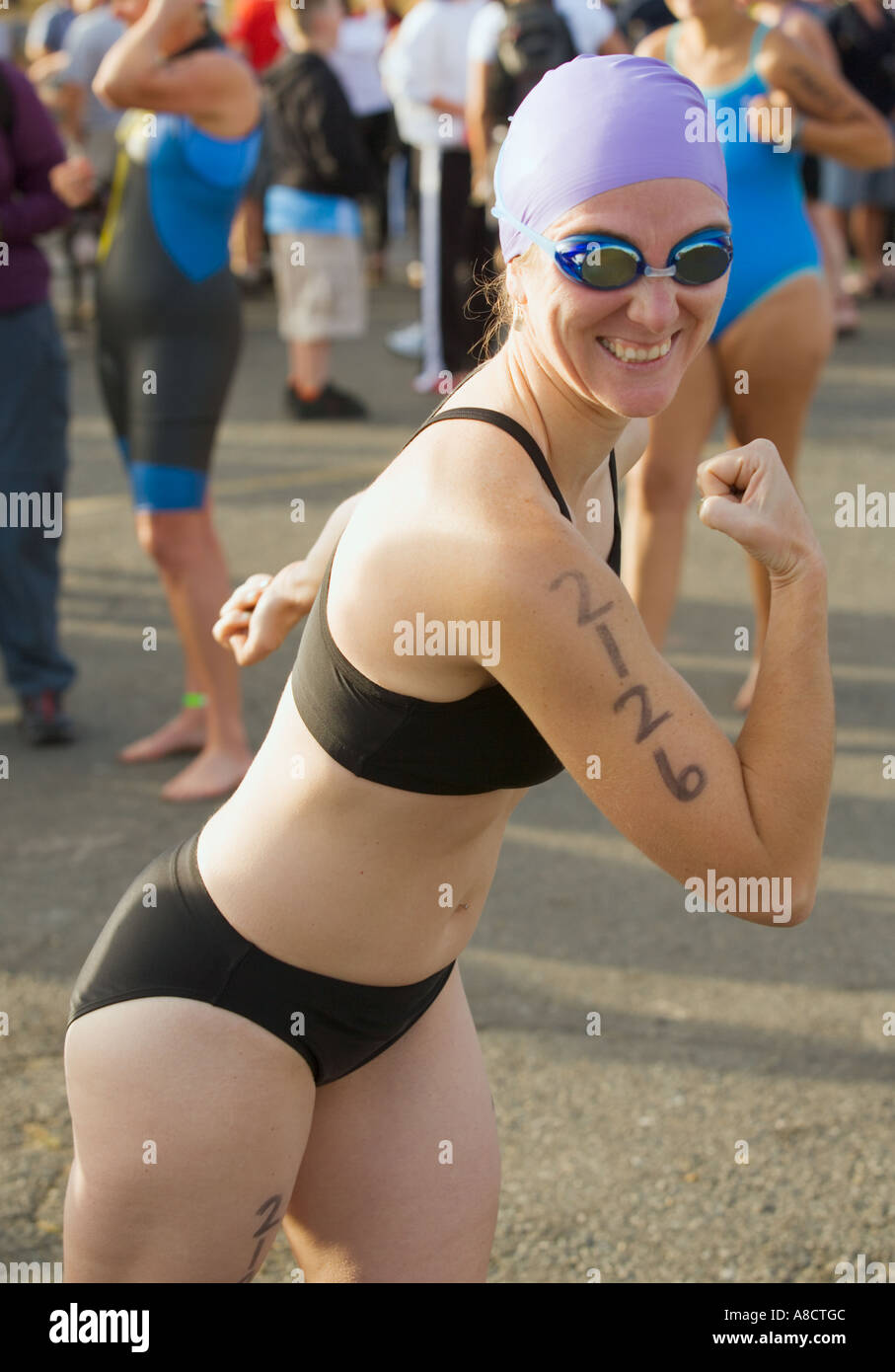 Female swimmer preparing for start of triathlon Stock Photo - Alamy