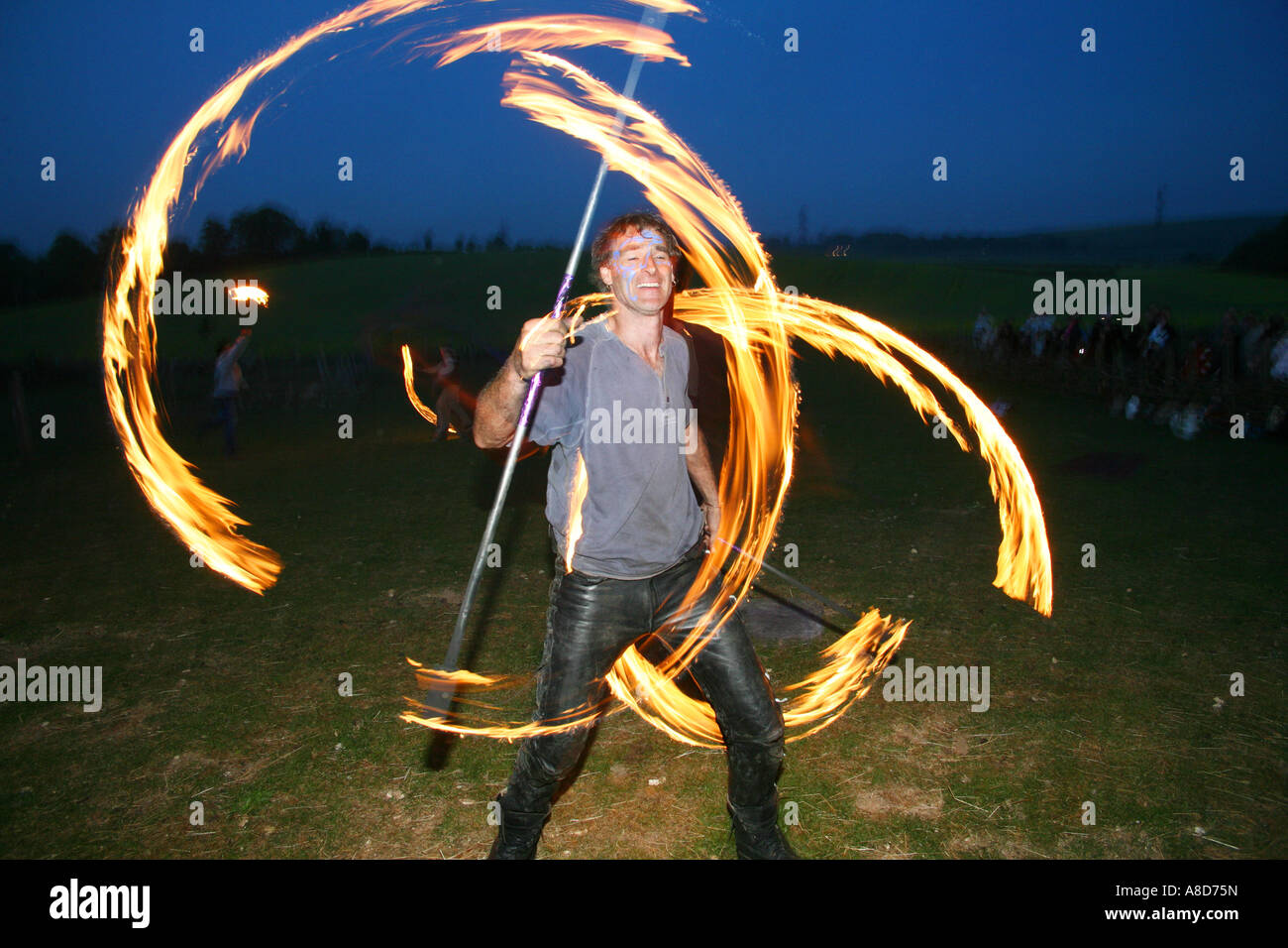 A flame acrobat performing at the Beltane festival at Butser Farm U K
