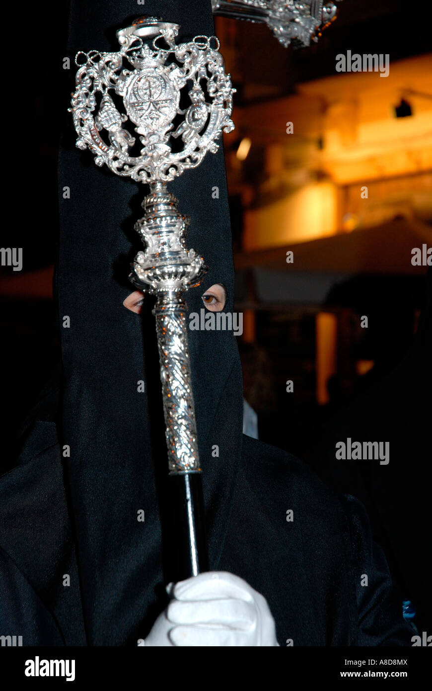 Black hooded man in Easter night procession, Spain Stock Photo