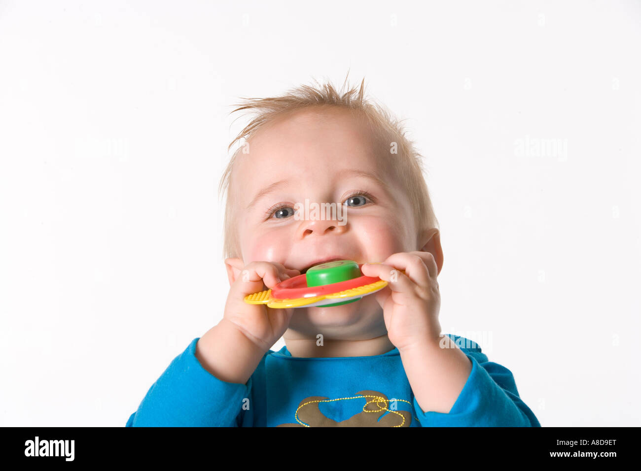 Little baby boy with a toy in his mouth Stock Photo - Alamy