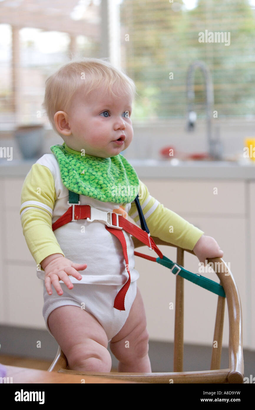 Baby standing in the baby chair in a rig Stock Photo