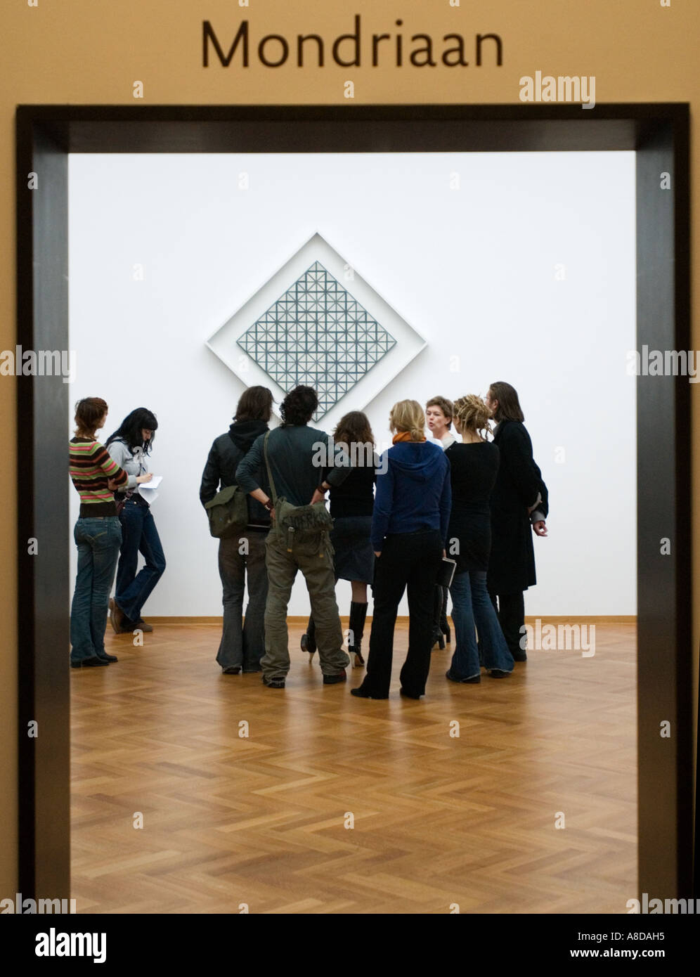 Art students studying abstract painting by Piet Mondriaan in Gemeentemuseum in The Hague Holland Stock Photo