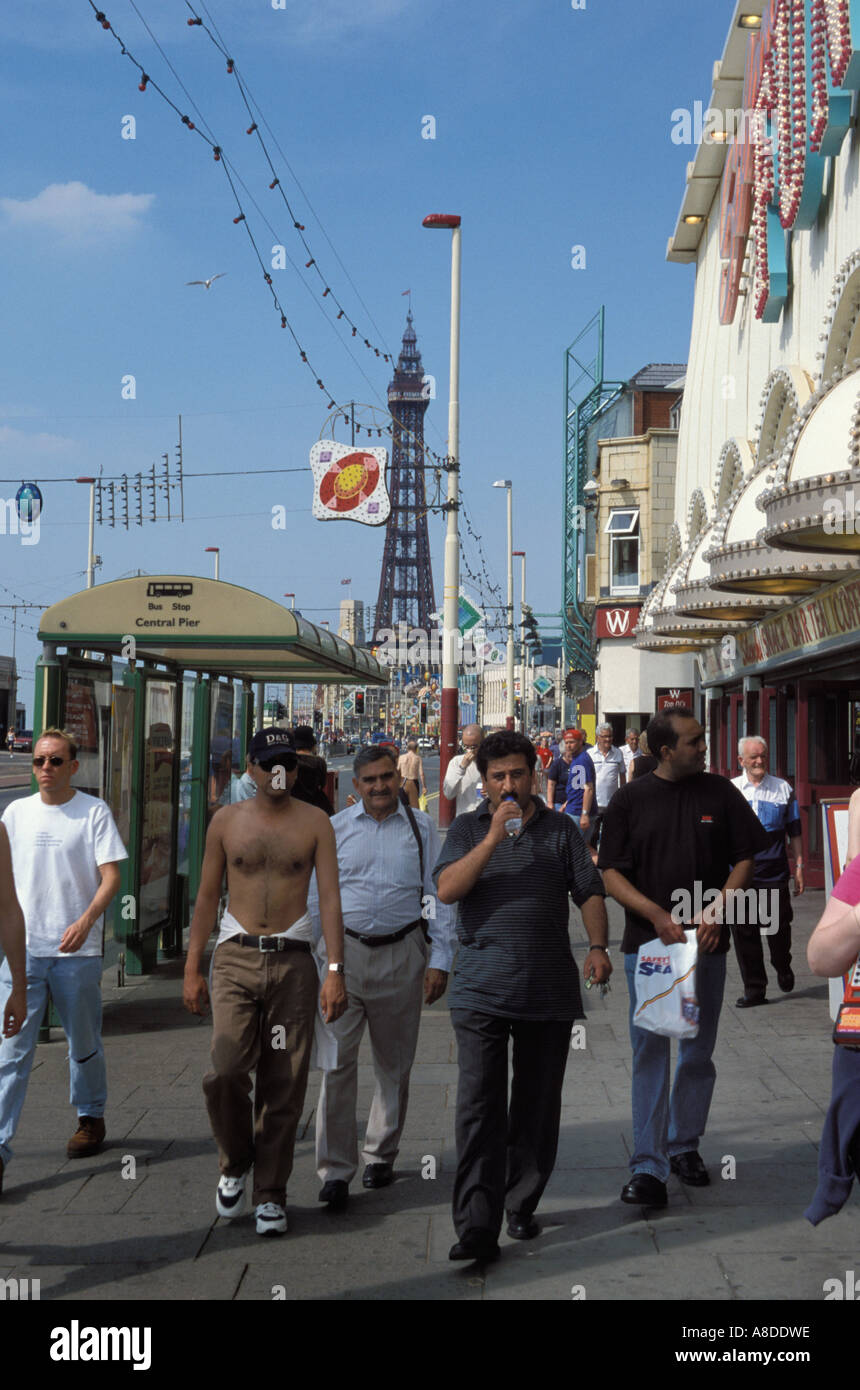 UK Blackpool Asian holiday makers on the promenade Stock Photo