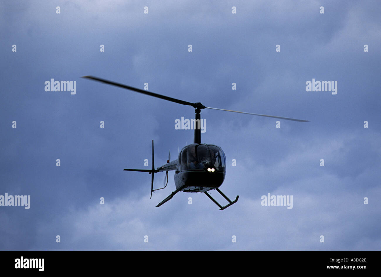Small Private Helicopter Flying Low Over Bawdsey Suffolk UK Stock small-private-helicopter-flying-low-over-bawdsey-suffolk-uk-stock