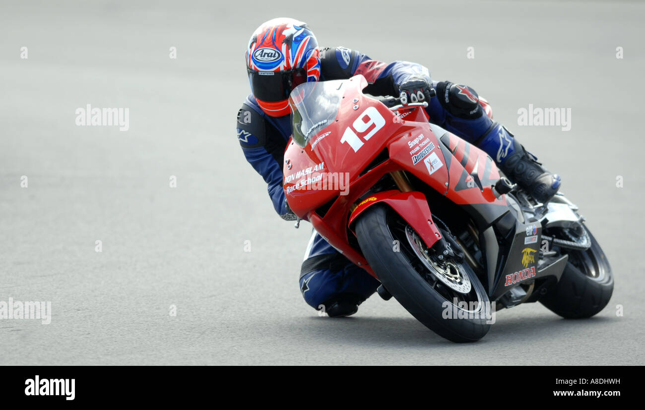 A MOTORCYLE RIDER GETS HIS KNEE  DOWN ON THE TRACK AT A TRACK DAY AT DONINGTON PARK IN LEICESTERSHIRE,UK. Stock Photo