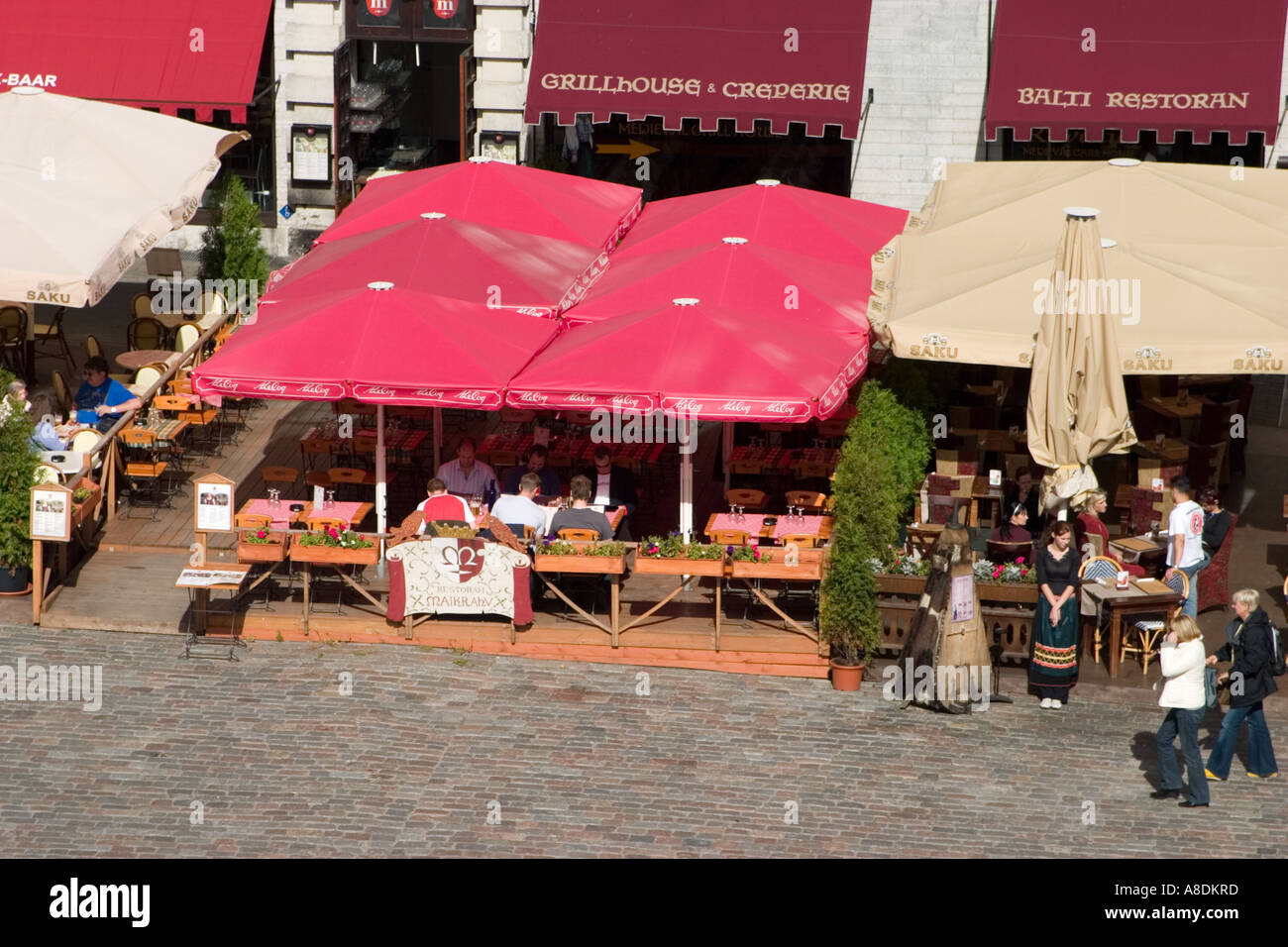 Outdoor restaurant with square red umbrellas Town Hall Square as seen from  top of Town Hall Old Town Tallinn Estonia Stock Photo - Alamy