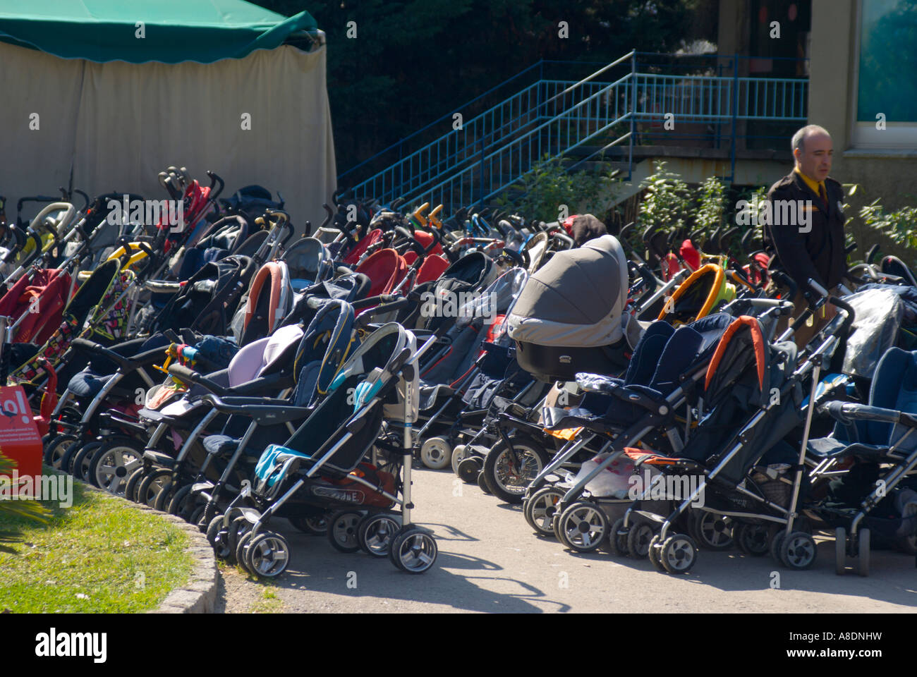 Barcelona baby strollers parked at the Zoo as parents take kids to see dolphin show Stock Photo