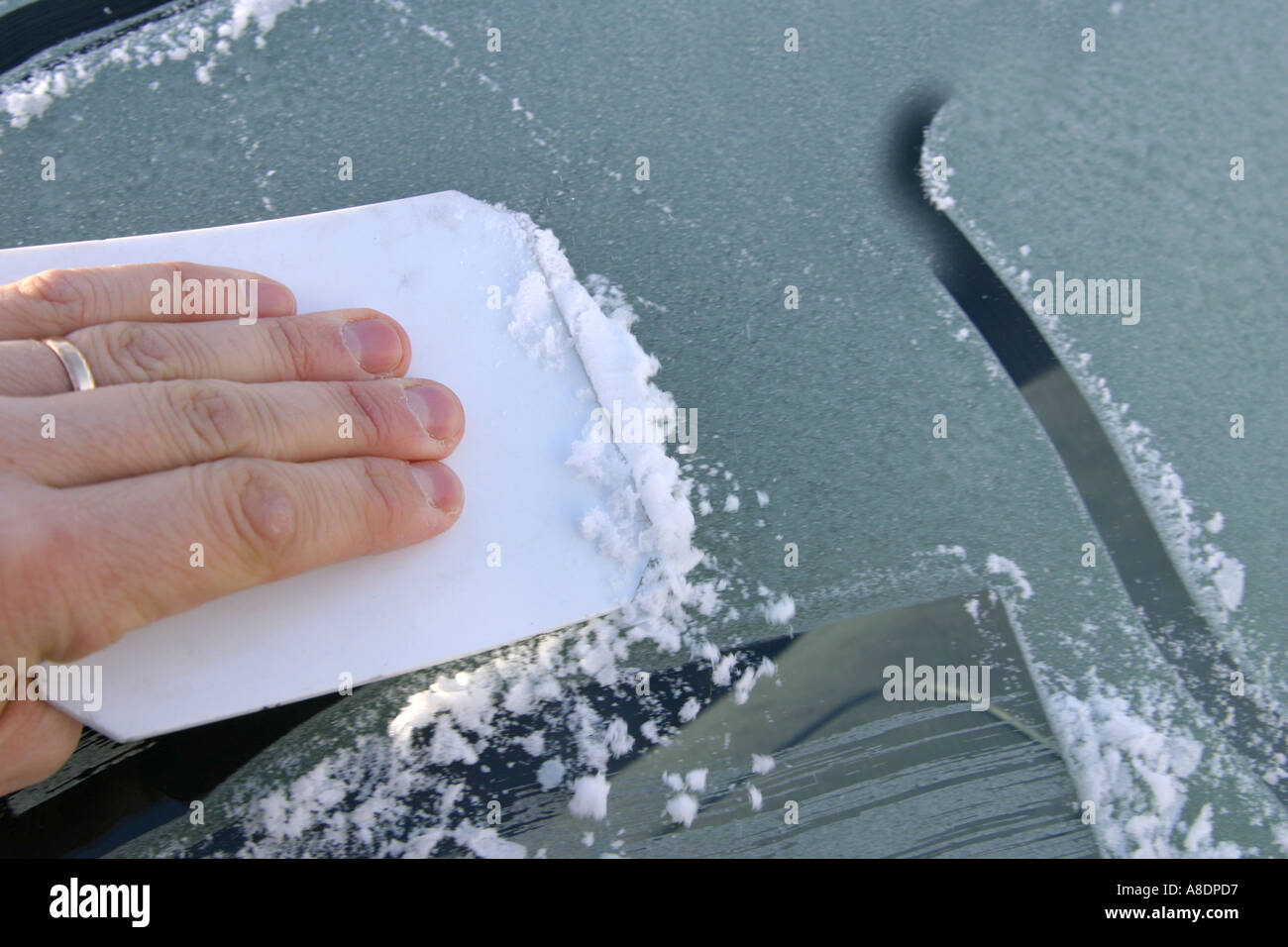 Scraping the frost off a windshield Stock Photo