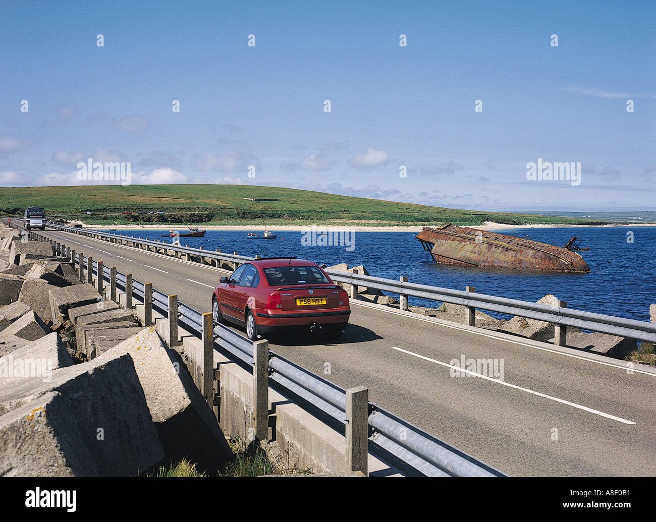 dh 3rd Churchill Barrier CHURCHILL BARRIERS ORKNEY Car driving on causeway road wartime block ship tourists motor tourist scapa flow historic scotland Stock Photo