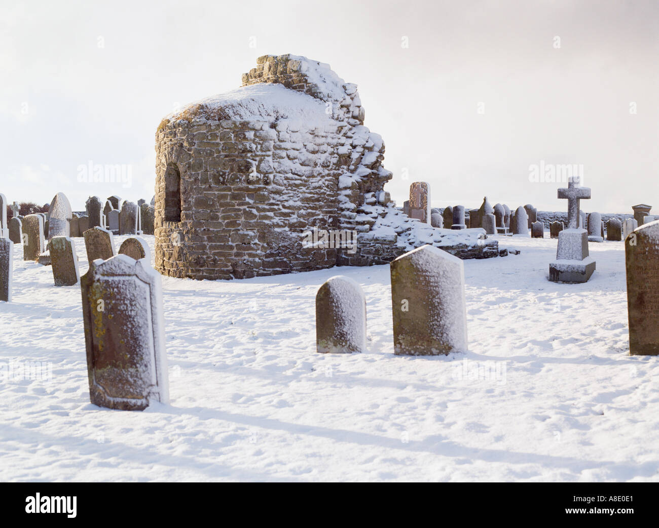 dh St Nicholas Church ORPHIR ORKNEY Round Kirk nave ruin and gravestone in snow Stock Photo