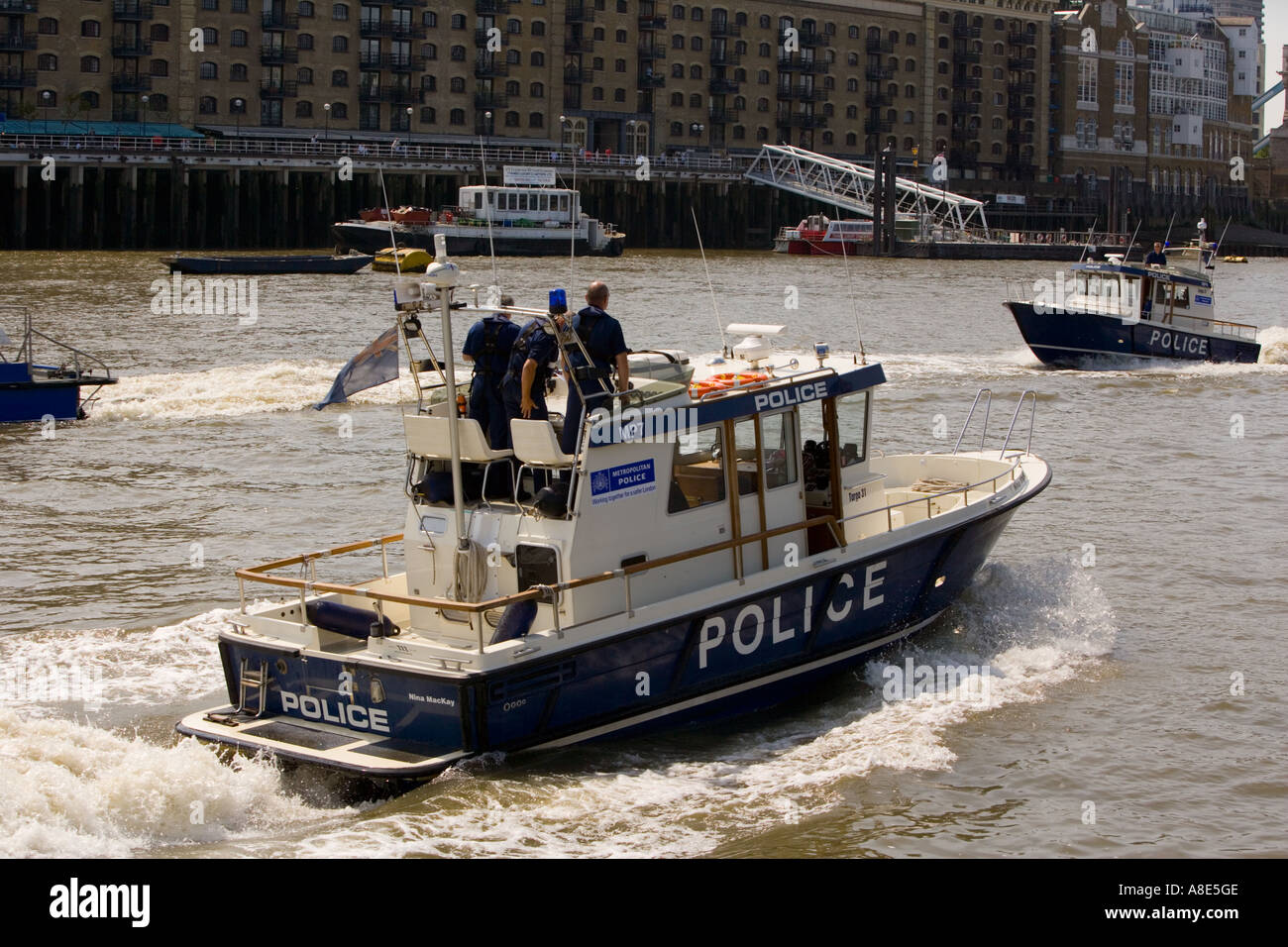 Police Patrol Boat 'Nina MacKay' meeting 'Sir Robert Peel' on the Thames Stock Photo