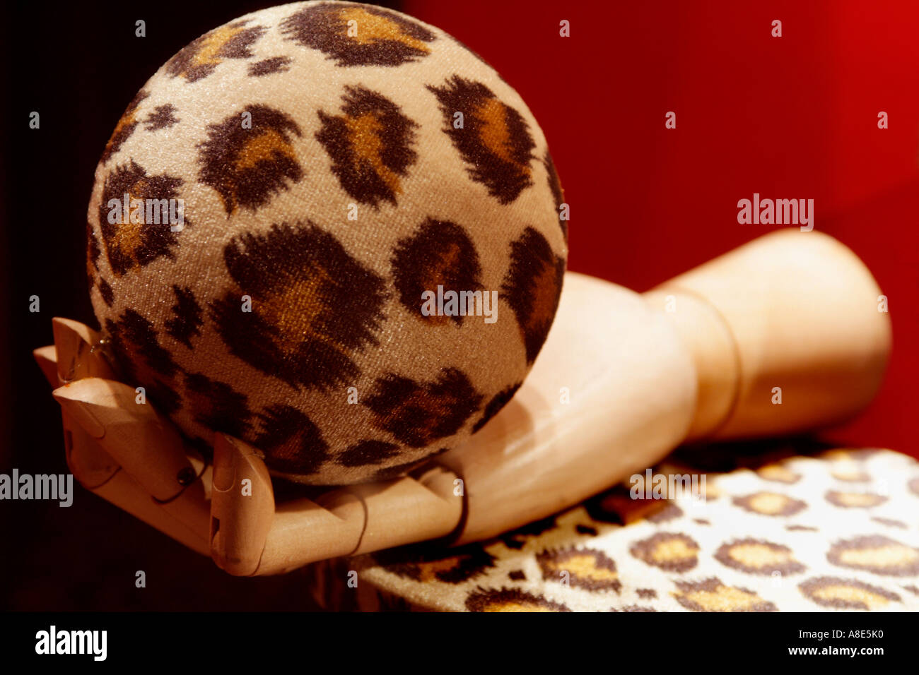 Artists Wooden Hand Model Holding  Leopard Cloth Covered Ball Stock Photo