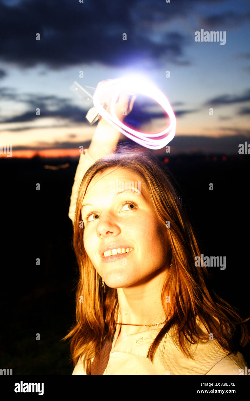 A women makes a halo with a torch Stock Photo