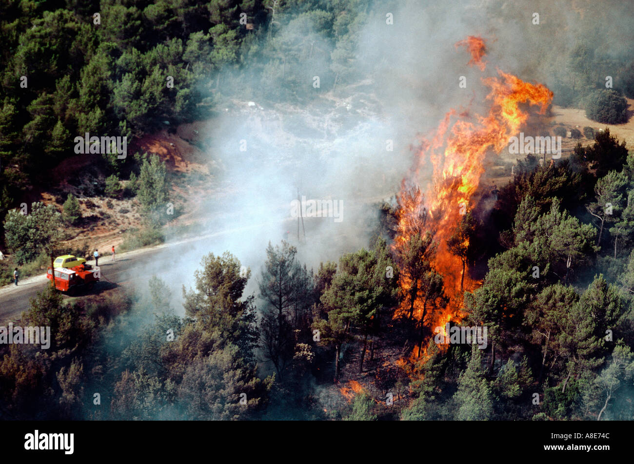 Aerial view of a wildfire, forest fire flames and smoke, firemen lorry, Bouches-du-Rhône, Provence, France, Europe, Stock Photo