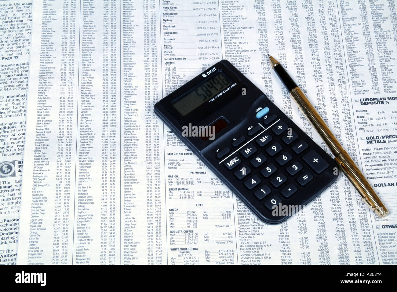 checking list of stocks and shares markets in detail on newspaper page equity prices with