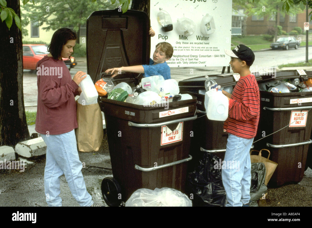 Multiethnic teens age 13 recycling plastics. St Paul Minnesota USA