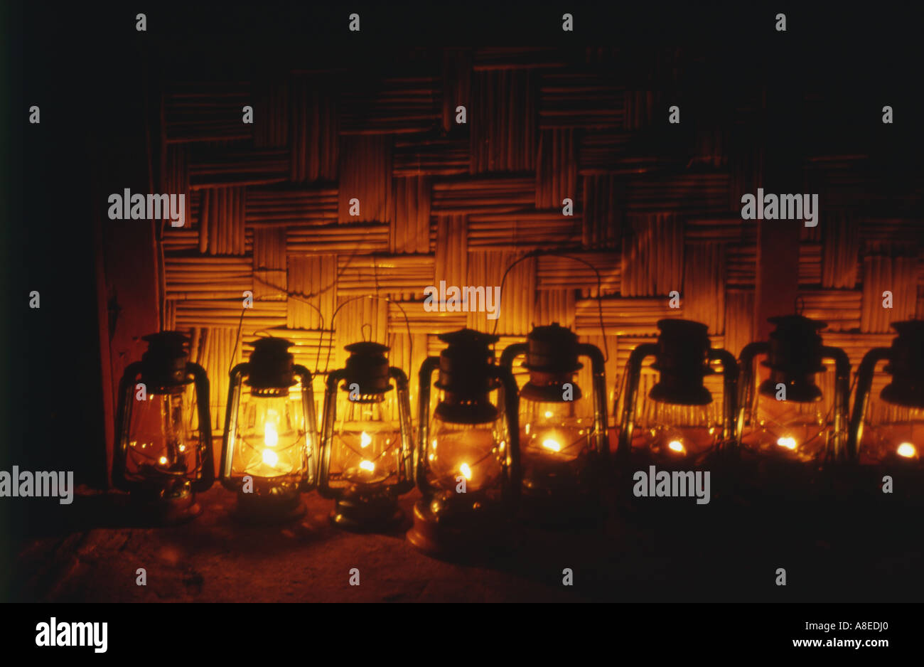 Line of paraffin lamps outsde a bamboo hut fiji south pacific Stock Photo