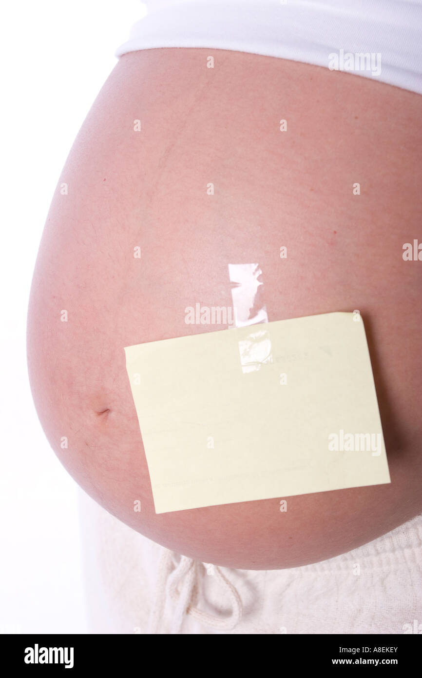 Blank sign sticked on a pregnant stomach to be filled with any copy