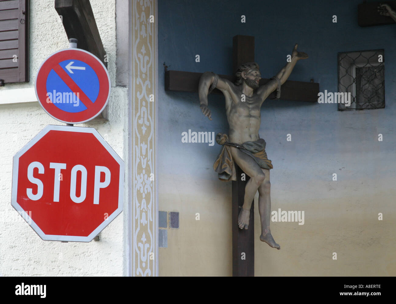 Crucifix next to a stop sign Stock Photo - Alamy