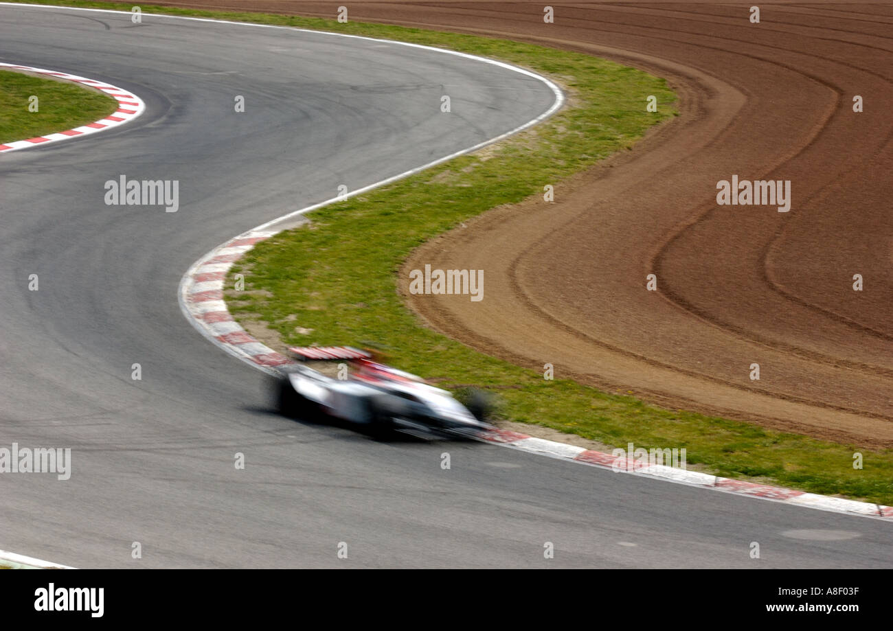 Formula 1 racing car on a track with curves Stock Photo - Alamy