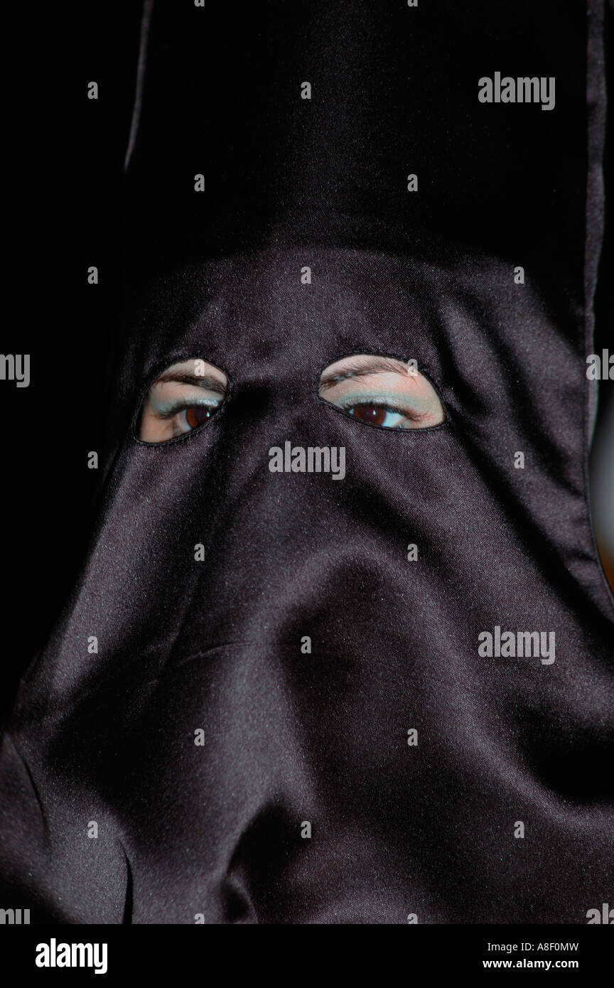 Woman wearing blue eye makeup and black hood at night procession, Easter, Malaga Stock Photo