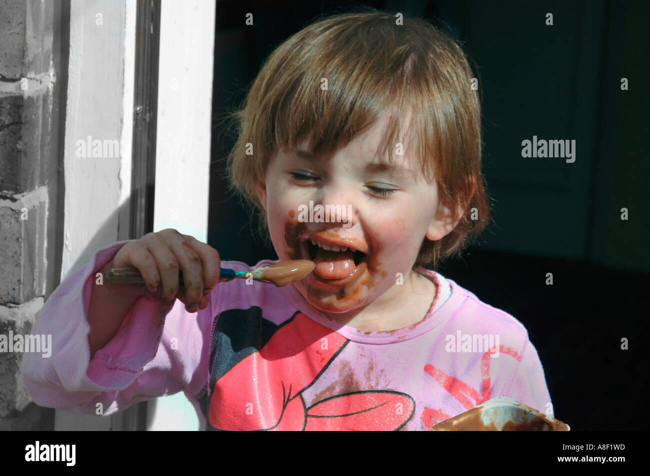 Little Girl Eating A Chocolate Pudding Stock Photo Alamy