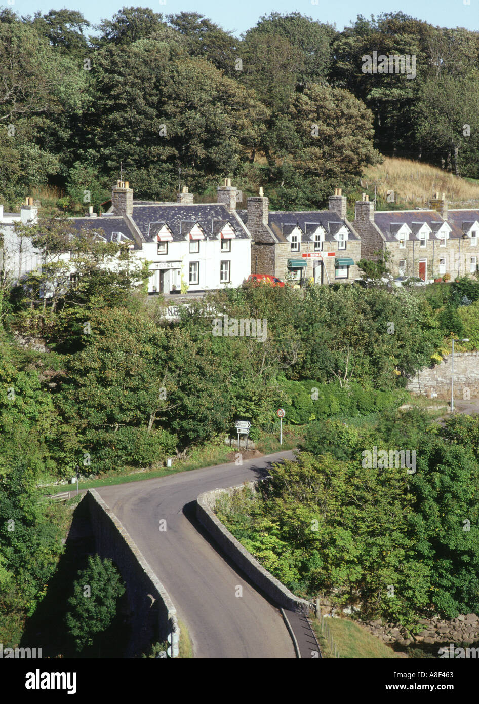 dh Old A9 DUNBEATH CAITHNESS Row of houses in village above road bridge