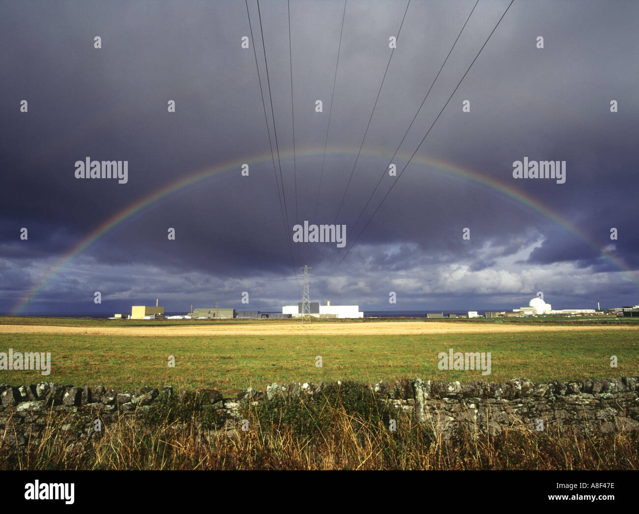dh DOUNREAY CAITHNESS Nuclear atomic reactor electricity power station lines rainbow black cloud Stock Photo