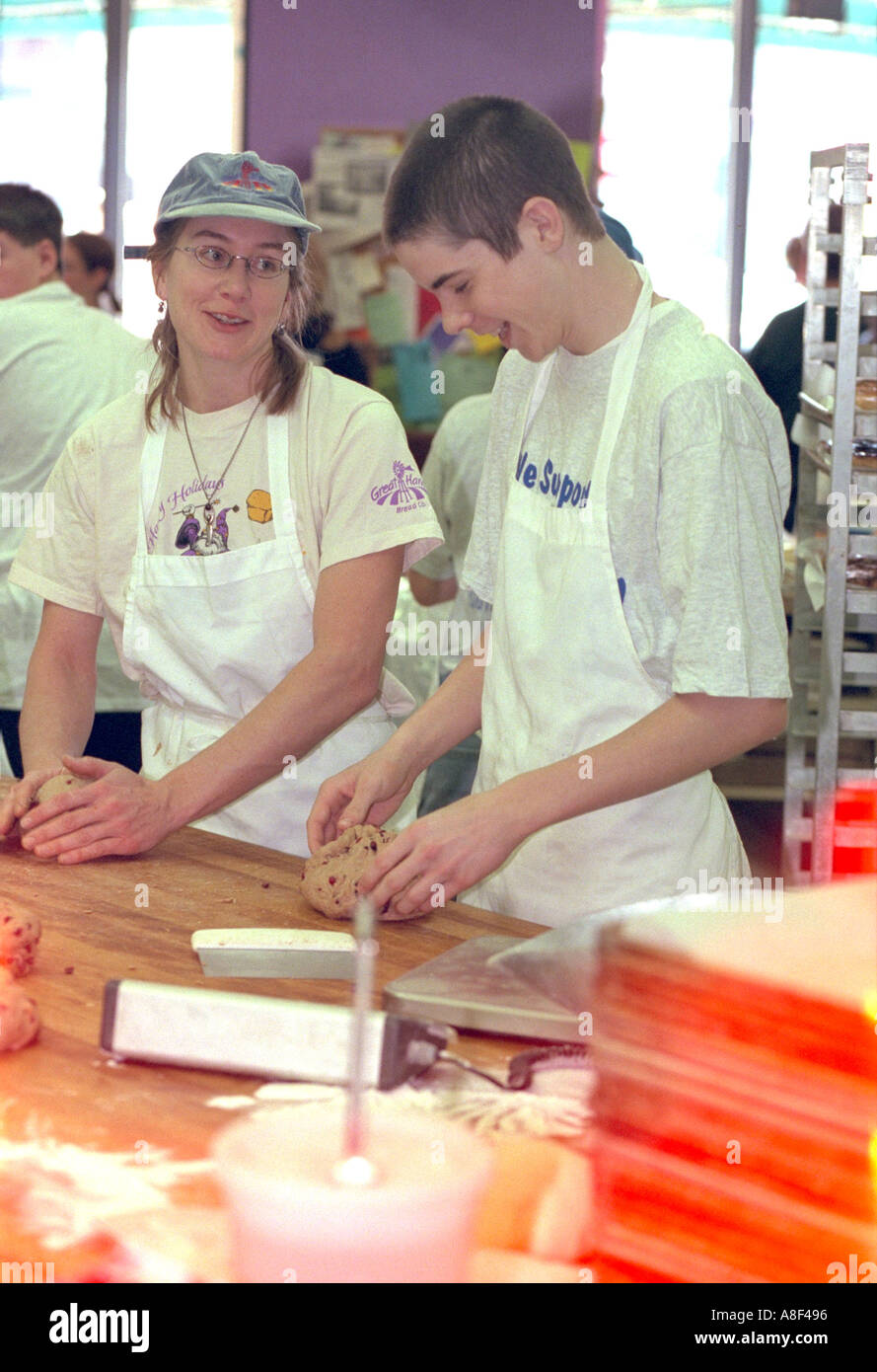 Youth Express team members shaping bread at fundraiser age 16 & 26. St Paul Minnesota USA Stock Photo