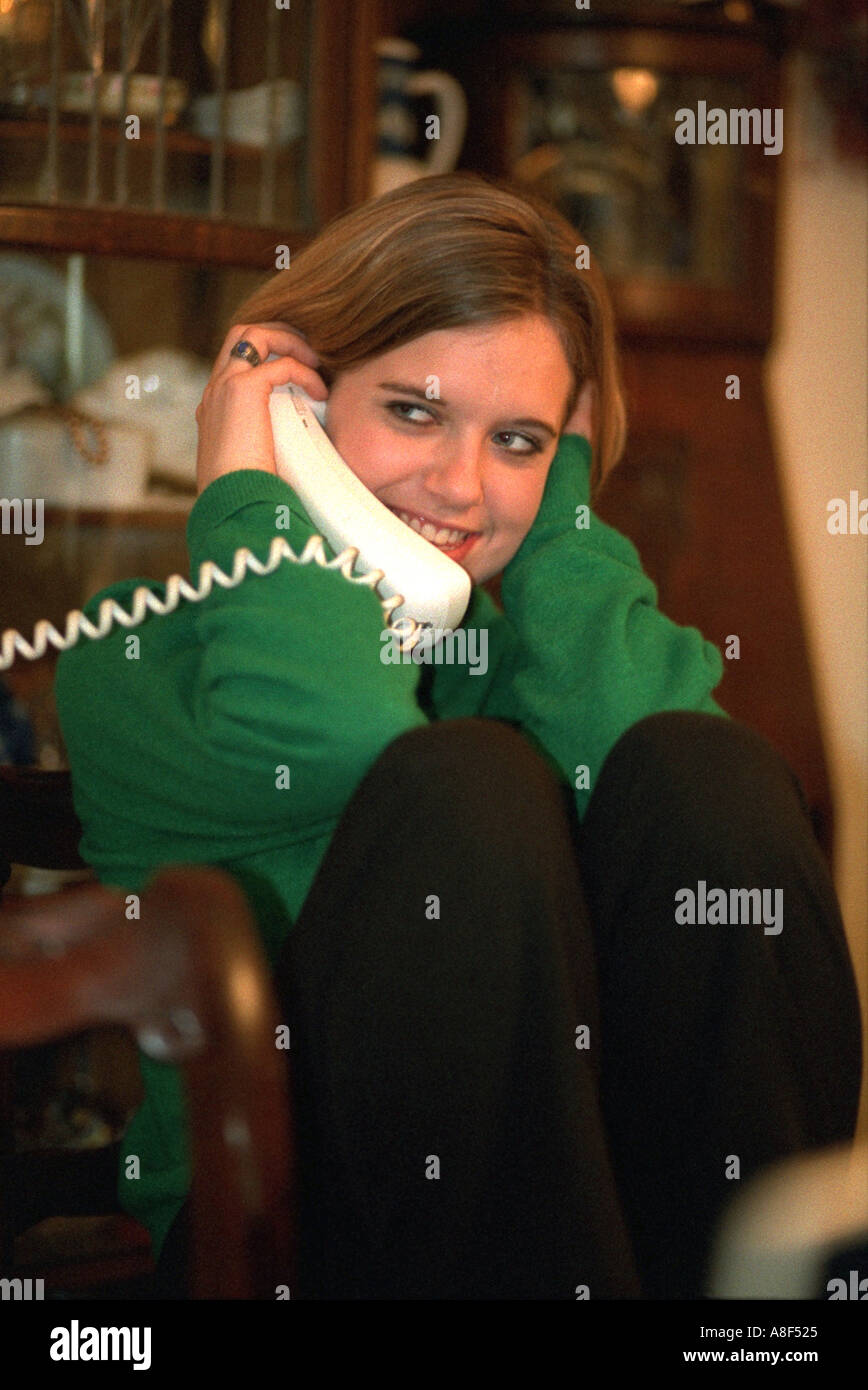 Granddaughter age 16 talking on phone at family Christmas party. Plymouth Minnesota USA Stock Photo