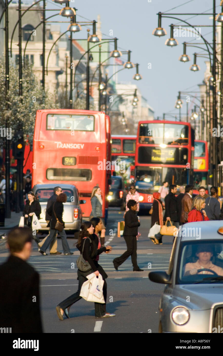 Shoppers and buses in Oxford Street, London, England, UK Stock Photo