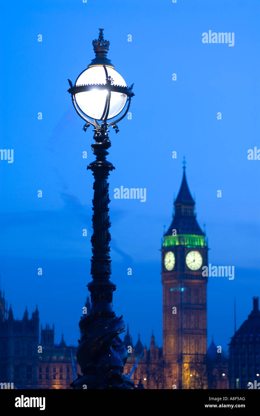 Ornate lamp post and Big Ben at night London England UK Stock Photo