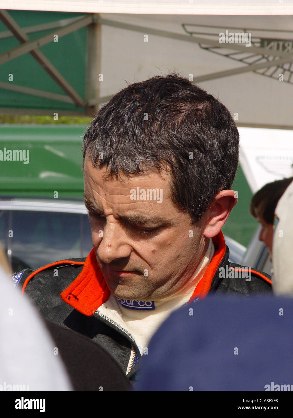 Rowan Atkinson signing autographs at a motor racing circuit England GB UK 2003 Stock Photo