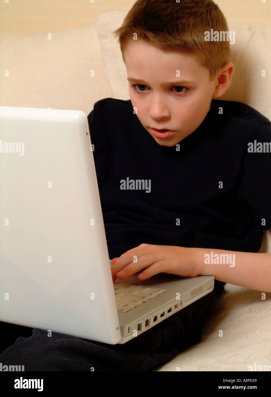 8 year old boy with a laptop computer Stock Photo