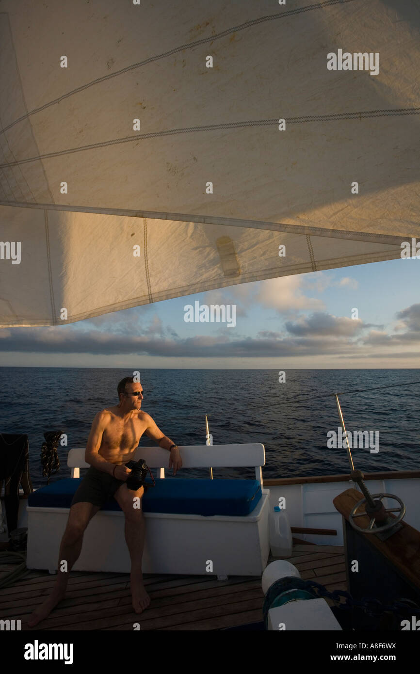 Man sitting on deck of a motor sailing boat Stock Photo - Alamy