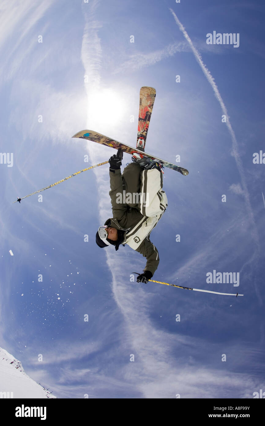 Skier in snow park inverted and spinning in total control. Stock Photo