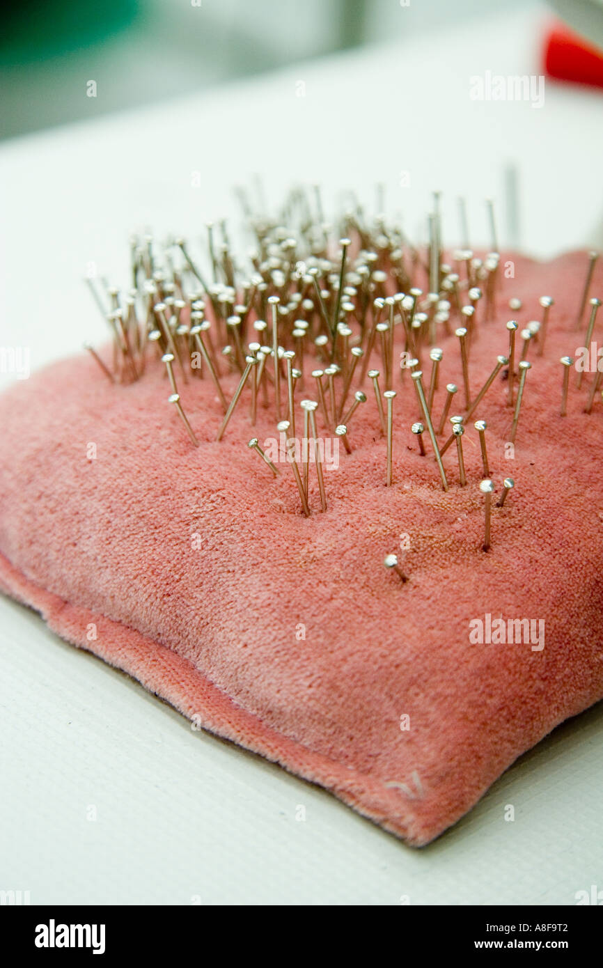 close up needle sewing machine work  clothes dress suit material, cloth horizontal sting cushion pillow pin Stock Photo