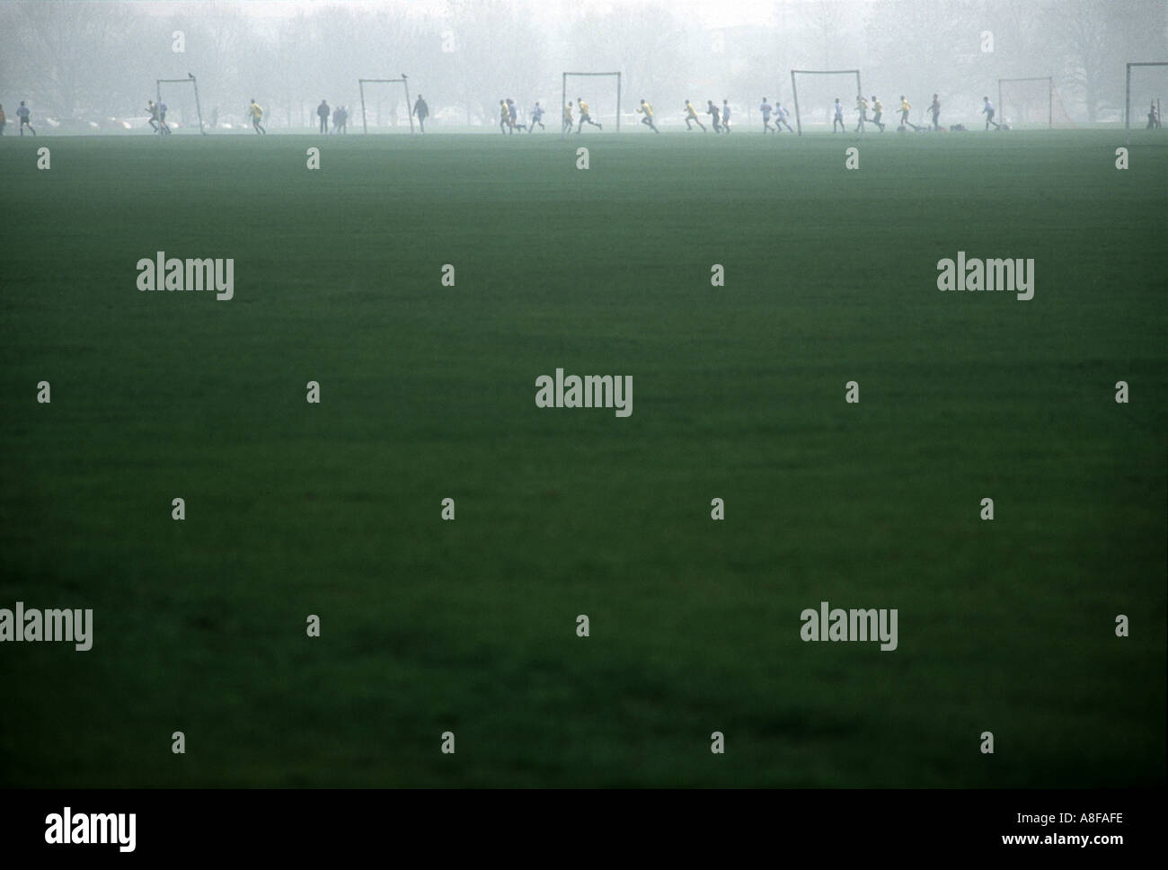 An amateur Sunday League football match with morning fog on Hackney Marshes, London, UK. Stock Photo