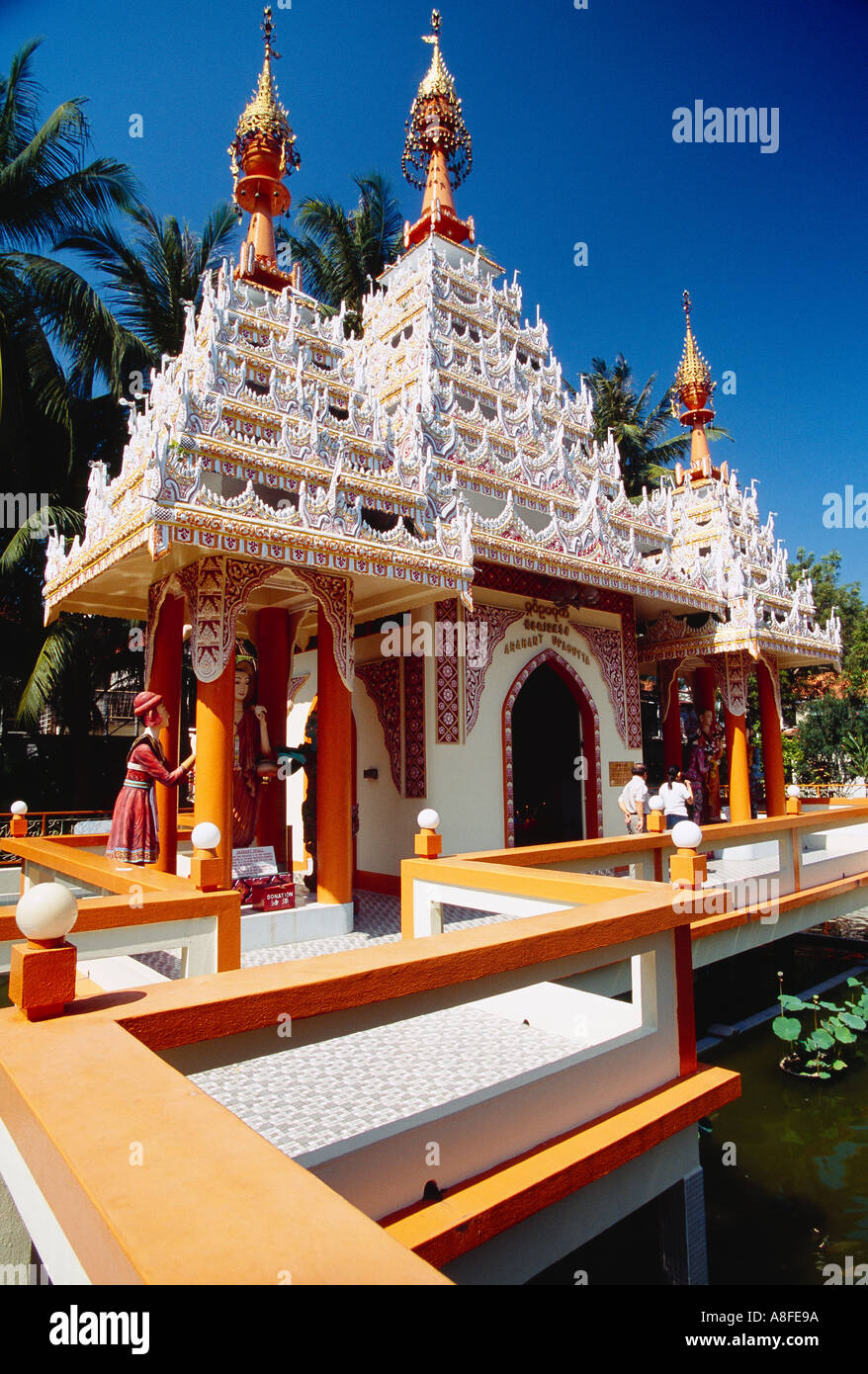 MALAYSIA Penang Island Georgetown Dharmikarama Burmese Temple Exterior with ornate carved roof and statues and visitors outside Stock Photo