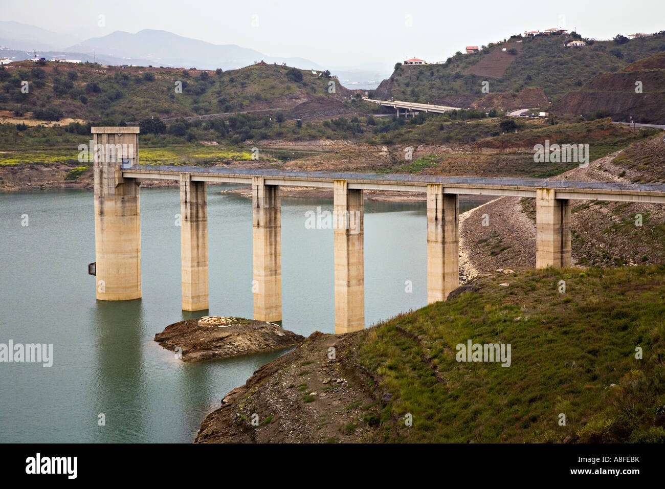 Valve tower at dam for reservoir with low water level Vinuela Andalucia Spain Stock Photo